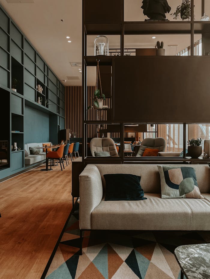 Chic living room interior with modern furniture, decor, and wooden flooring.
